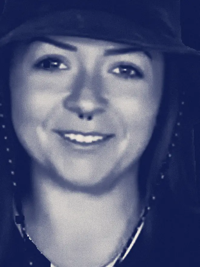 Lindsay Nikole, in a dark bucket hat, smiles at the camera.