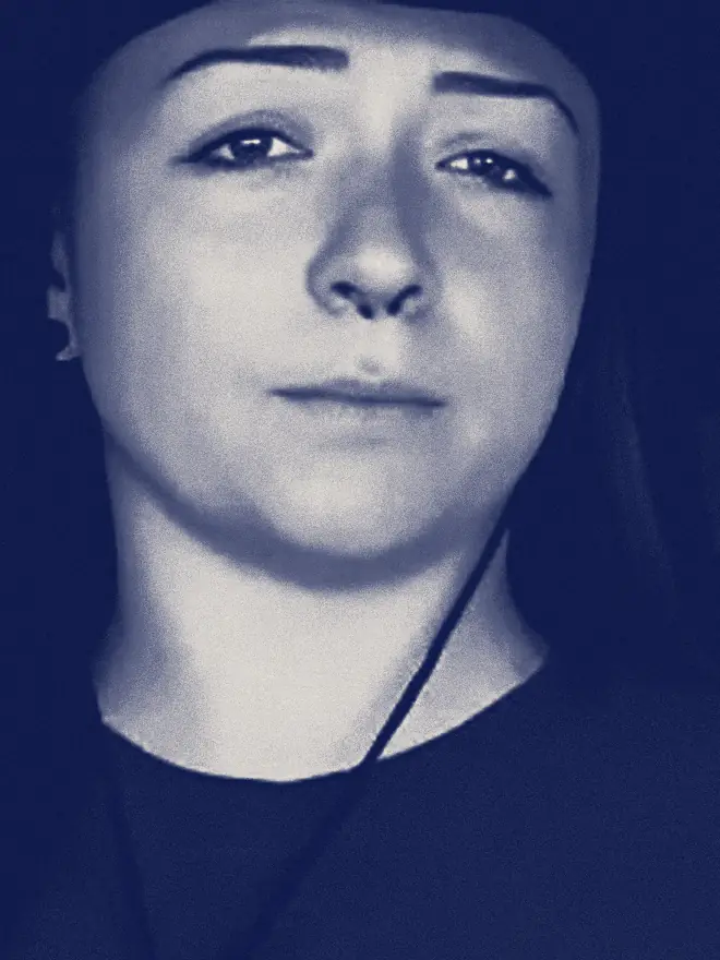 Lindsay Nikole looks at the camera with one eyebrow raised.
